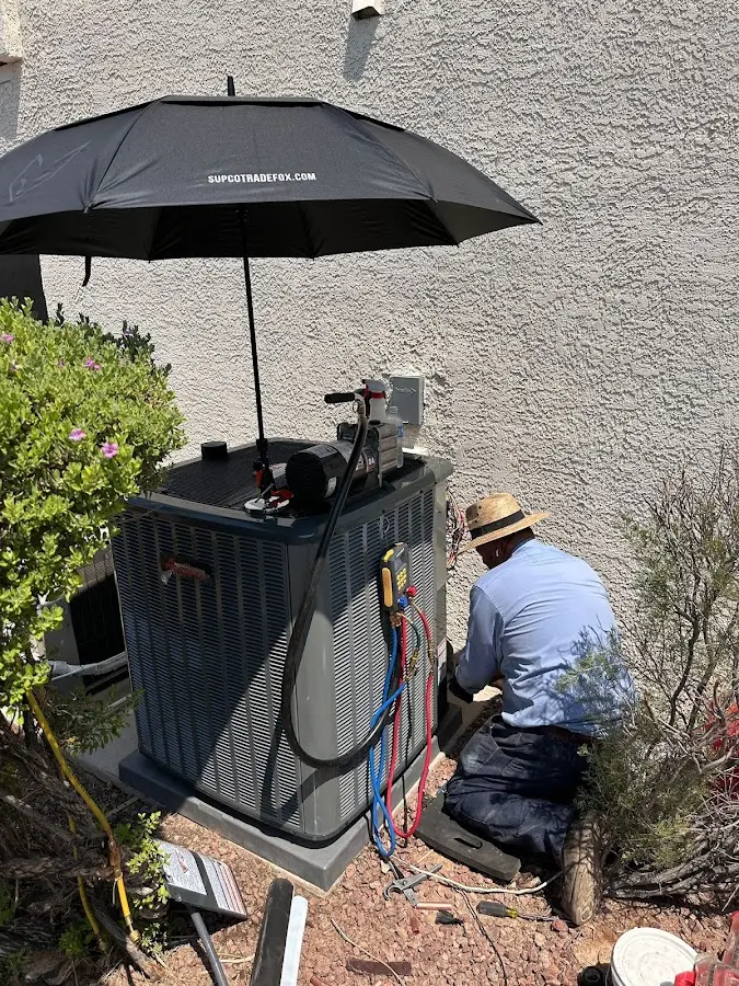 HVAC technician performing outdoor AC maintenance in Roosevelt